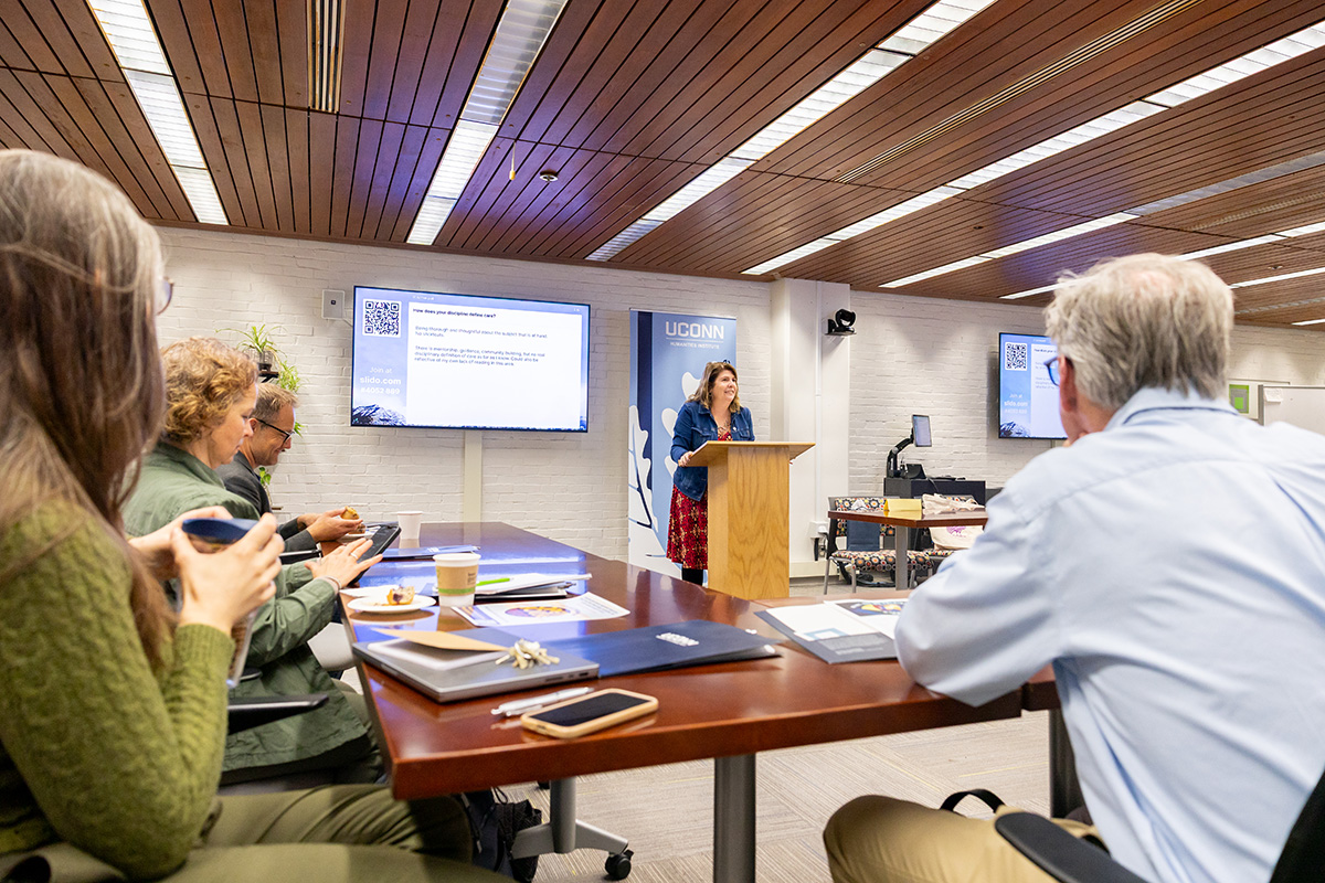 Anne Mae Duane, director of the UConn Humanities Institute, gives the opening remarks for the Institute's "What are we talking about when we talk about AI?" symposium in the Homer Babbidge Library on Thursday, Oct. 9, 2025.