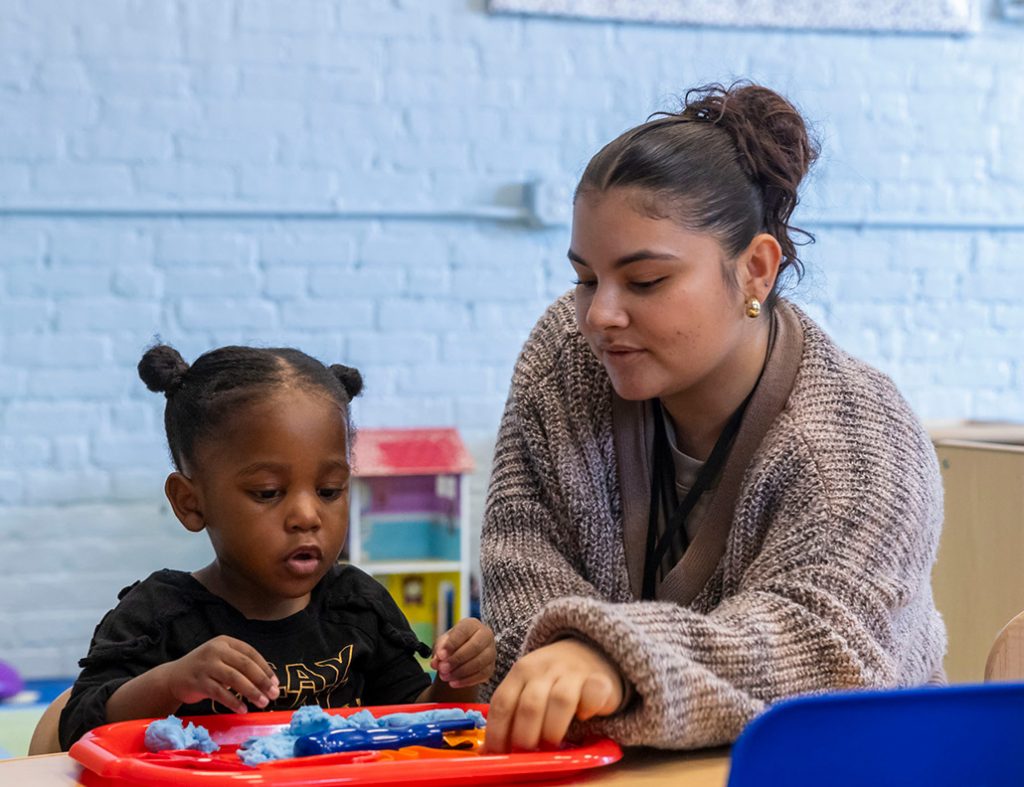 A student works with a child in a learning lab.