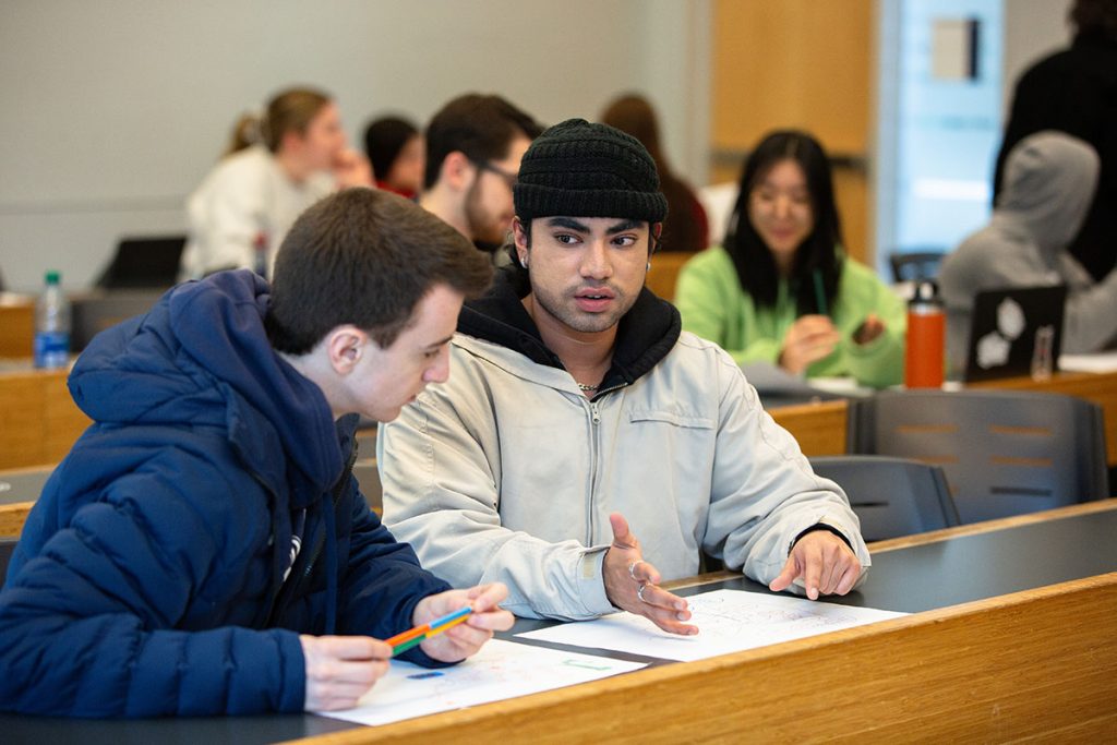 Two students in a discussion while working in a class group.