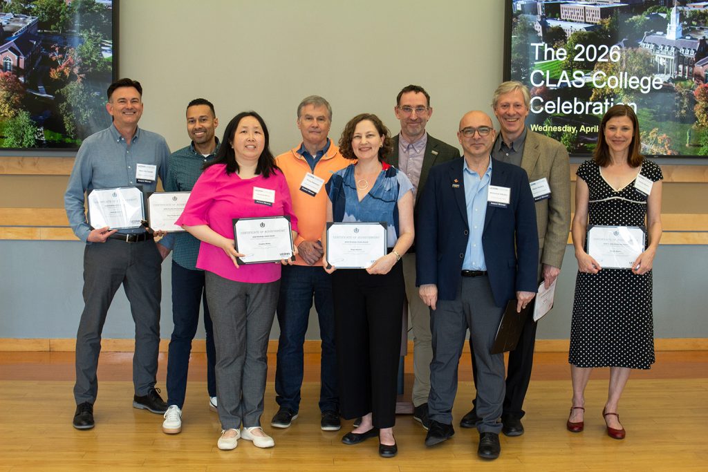 A group of CLAS Faculty and Staff Award Recipients pose with their certificates and the dean during the 2026 award ceremony. 
