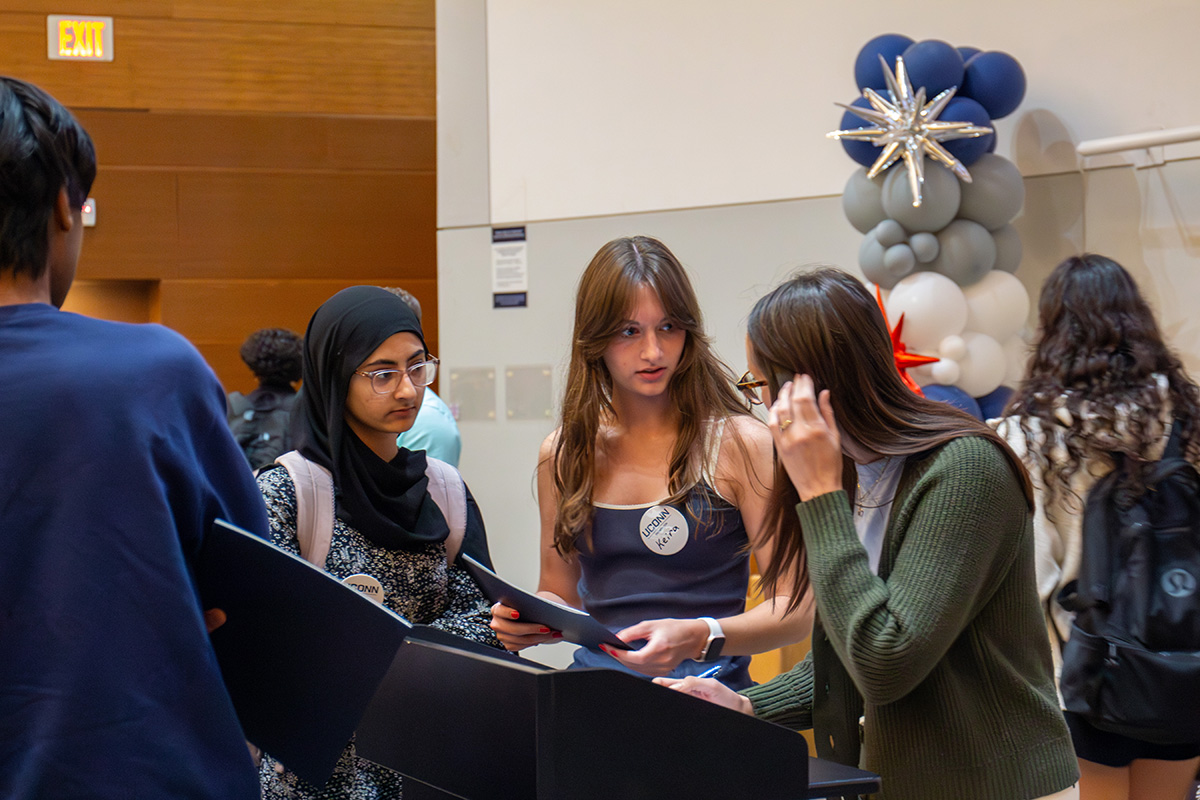 CLAS students talk to an advisor at a new student orientation session.