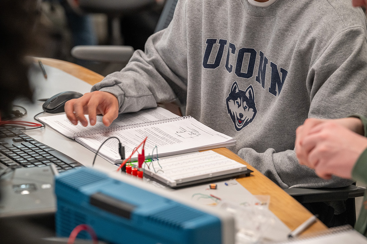 A student works on a physics lab project in class. 