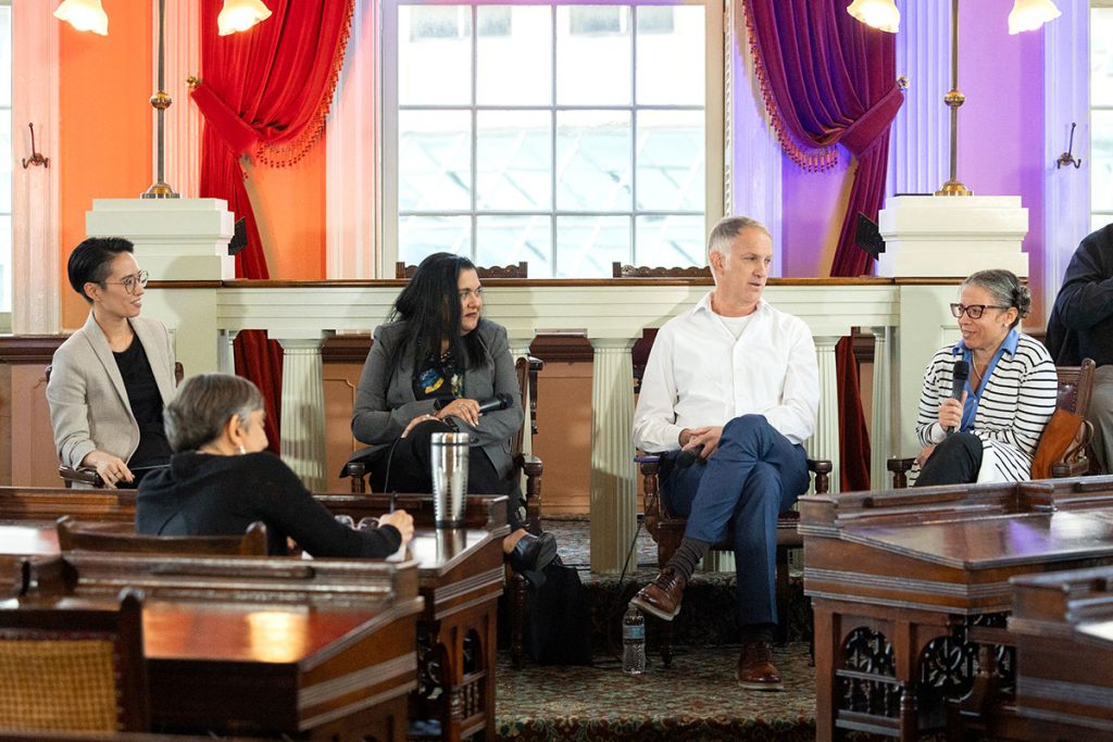 A faculty panel discussion at an outreach event.